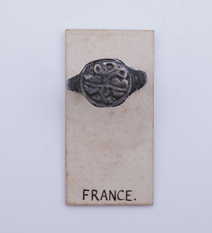A sentimental signet ring, France, circa 16th century, the circular panel depicting two hearts tied in a true lover's knot, size R1/2, labelled 2244, Provenance: formerly in the collection of Dame Joan Evans (1893-1977)